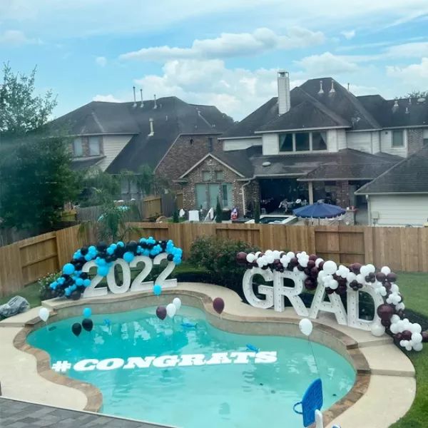 an inflatable pool with balloons and letters that spell out the word grad