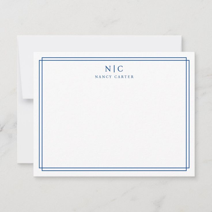 a white card with blue border and the word nic on it, next to an envelope