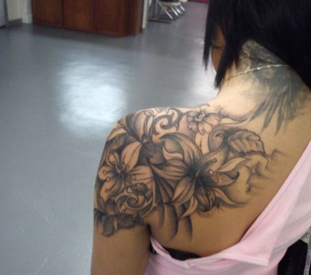 the back of a woman's shoulder with flowers on it