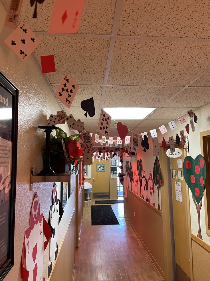 an office hallway decorated for valentine's day with paper hearts hanging from the ceiling