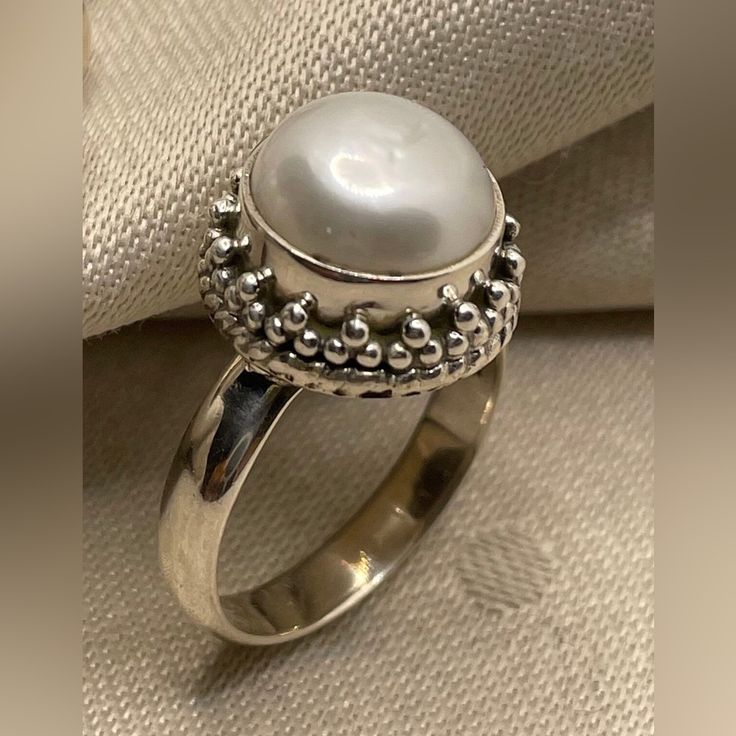 Introducing Our Stunning 925 Sterling Silver Pearl Rings Featuring Beautiful Granulation Accents And Intricate Twisted Wire Work. Perfect For Those Who Appreciate Fine Craftsmanship And Timeless Elegance. Https://Www.Instagram.Com/Reel/C7nz85mnvl7/?Igsh=Mzrlodbinwflza== Product Details: Product: Ring Metal: 925 Sterling Silver Sizes Available: Us 6, 8, And 9 Pearl Size: 10mm Round Total Weight: 7.25 Grams These Rings Showcase A Gorgeous Pearl Set In High-Quality Silver, Enhanced By Delicate Gran White Sterling Silver Pearl Ring Gift, Elegant Sterling Silver Cabochon Pearl Ring, White Sterling Silver Ring Jewelry, Cabochon Pearl Ring In Sterling Silver, Oval Sterling Silver Hallmarked Pearl Ring, White Pearl Ring Stamped 925, Hallmarked Oval Pearl Ring In Sterling Silver, White Fine Jewelry Rings Stamped 925, Hallmarked Sterling Silver Oval Pearl Ring