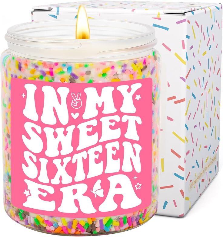 a candle that is inside of a glass jar with sprinkles on it