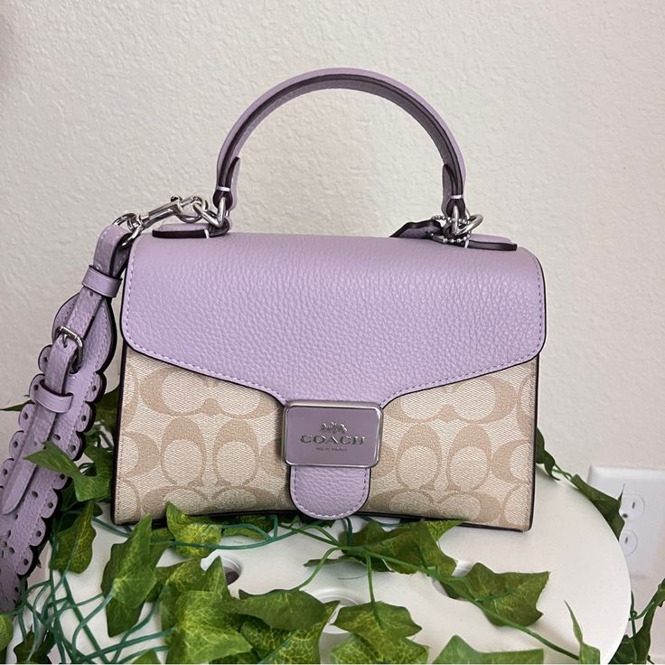 Signature Coated Canvas And Refined Pebble Leather Inside Multifunction Pocket Snap Closure, Fabric Lining Top Handle With 2 3/4" Drop Outside Open Pocket Detachable Strap With 22 1/2" Drop For Shoulder Or Crossbody Wear 8 3/4" (L) X 6" (H) X 4" (W) Style No. Ca233 Coach Purple Shoulder Bag With Top Carry Handle, Coach Purple Bag With Top Carry Handle, Purple Double Handle Shoulder Bag With Detachable Strap, Purple Shoulder Bag With Detachable Double Handle, Chic Purple Bags With Detachable Strap, Coach Rectangular Purple Shoulder Bag, Coach Purple Rectangular Shoulder Bag, Rectangular Purple Coach Shoulder Bag, Coach Purple Bag With Detachable Handle