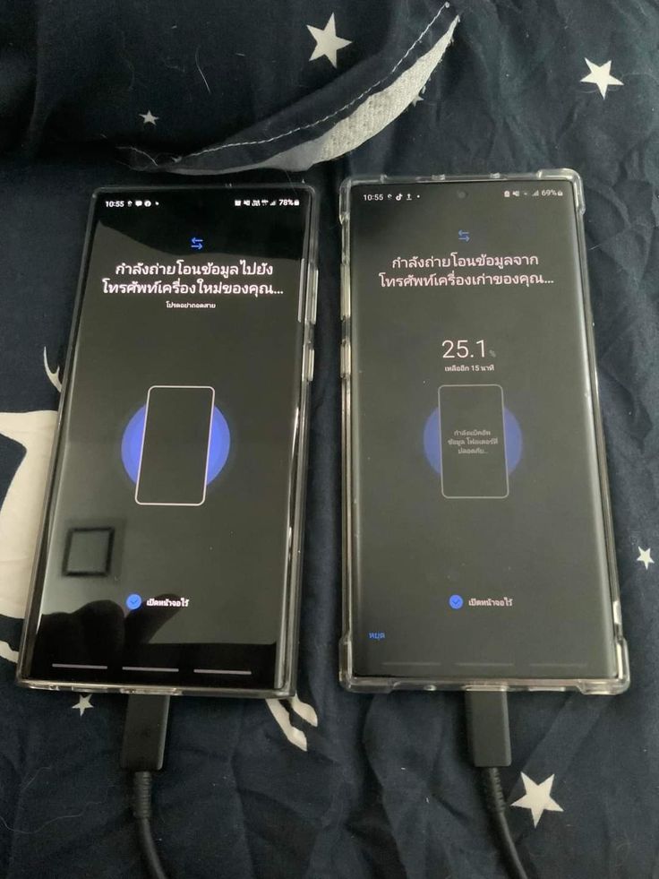 two samsung phones sitting next to each other on a bed