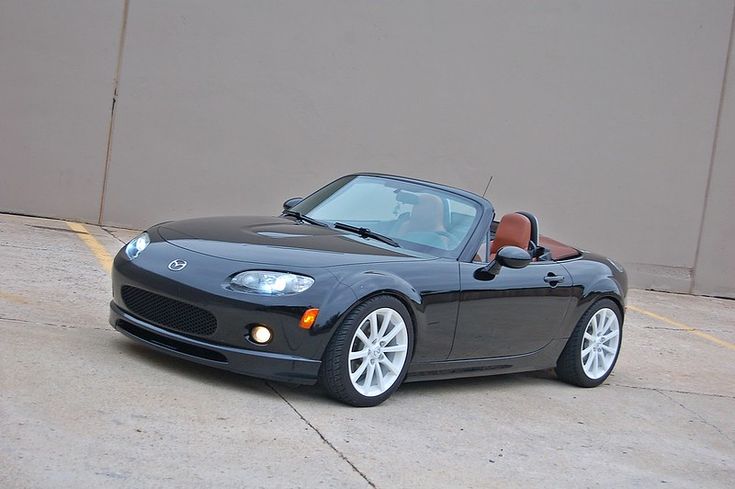 a black sports car parked in front of a building