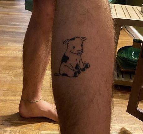 a man's leg with a dog tattoo on it