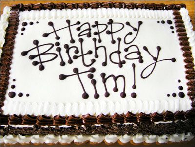 a birthday cake with the words happy birthday tim written in chocolate icing on it