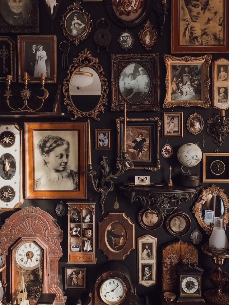 a wall covered in lots of different types of framed pictures and clock faces on it's sides