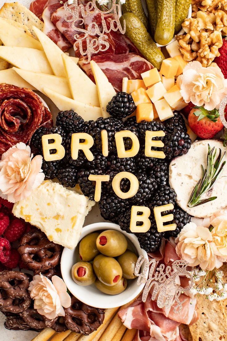 the words bride to be spelled in gold letters surrounded by food