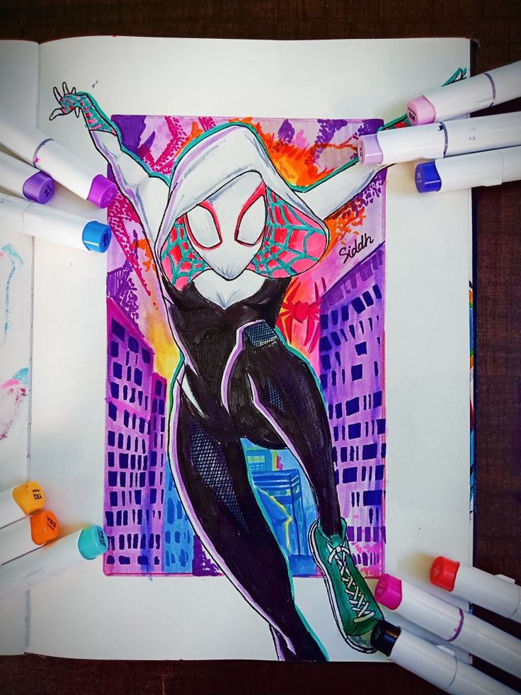 a drawing of a spider woman with her arms in the air, surrounded by crayons