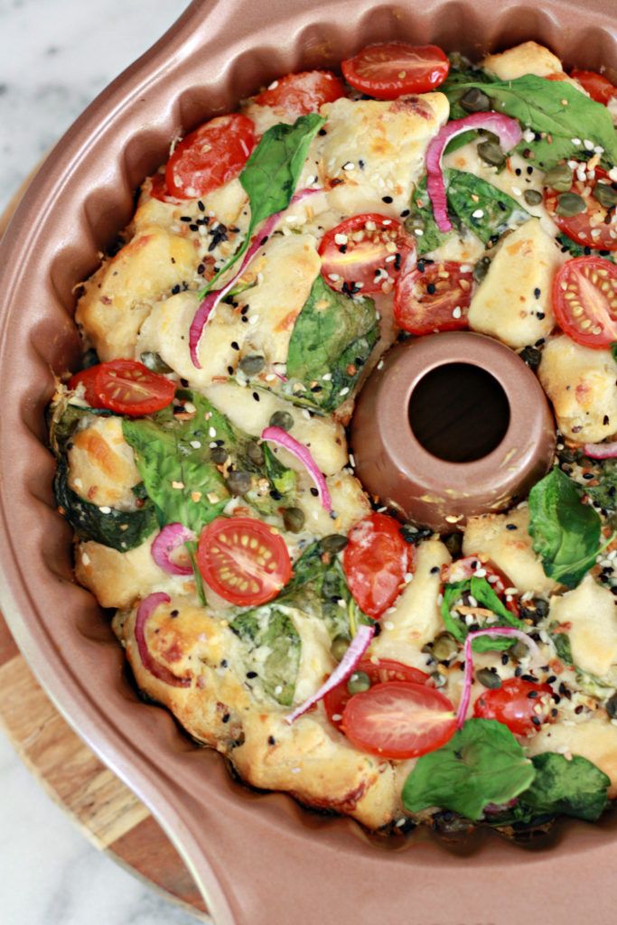 a pizza sitting on top of a pan covered in cheese and veggie toppings