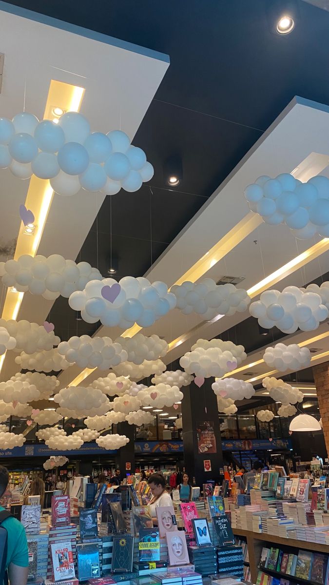 the ceiling is decorated with paper clouds and bookshelves in a bookstore or book store