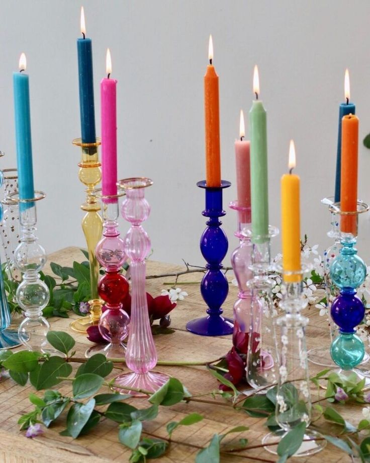 a table topped with lots of different colored candles