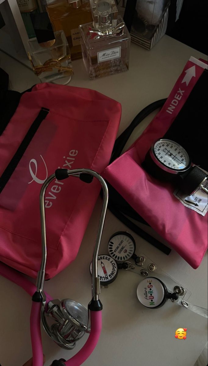 a stethoscope sitting on top of a table next to a pink bag