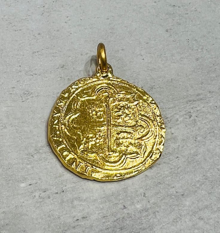 Large Atocha Coin Pendant in 24K Solid Gold. Pure Solid Gold . We are inspired by the Historic Atocha coin and designed our pendant in pure 24K solid gold.(.999 pure) 1.25 Inches/ 30mm in Diameter and approximately one full ounce of 24K Gold- Approximately 31 Grams of Gold. Nuestra Señora de Atocha  was a Spanish treasure galleon that sank in a hurricane near the Florida Keys in 1622.  At the time of her sinking, Atocha was heavily loaded with silver, gold,  gems and other treasures  bound for S Gold Engraved Amulet-style Coin Necklace, Gold Engraved Amulet Coin Necklace, Gold Engraved Coin Amulet Necklace, Traditional Gold Coin Jewelry, Gold Engraved Coin Necklace In Amulet Style, Gold Coin Necklace With Large Amulet Pendant, Traditional Gold Coin Necklace With Round Pendant, Traditional Gold Coin Necklace Gift, Traditional Gold Coin Necklace As Gift