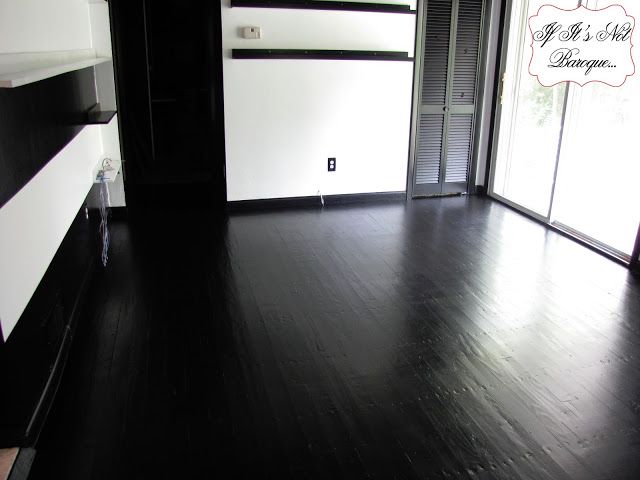 an empty room with black and white furniture