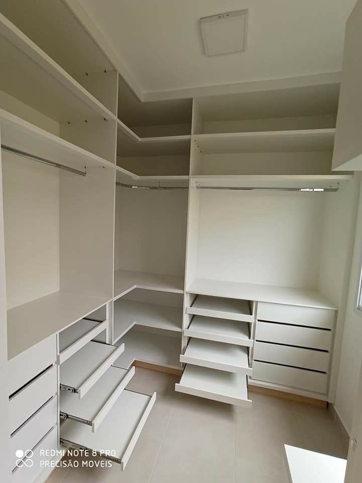 an empty walk in closet with shelves and drawers