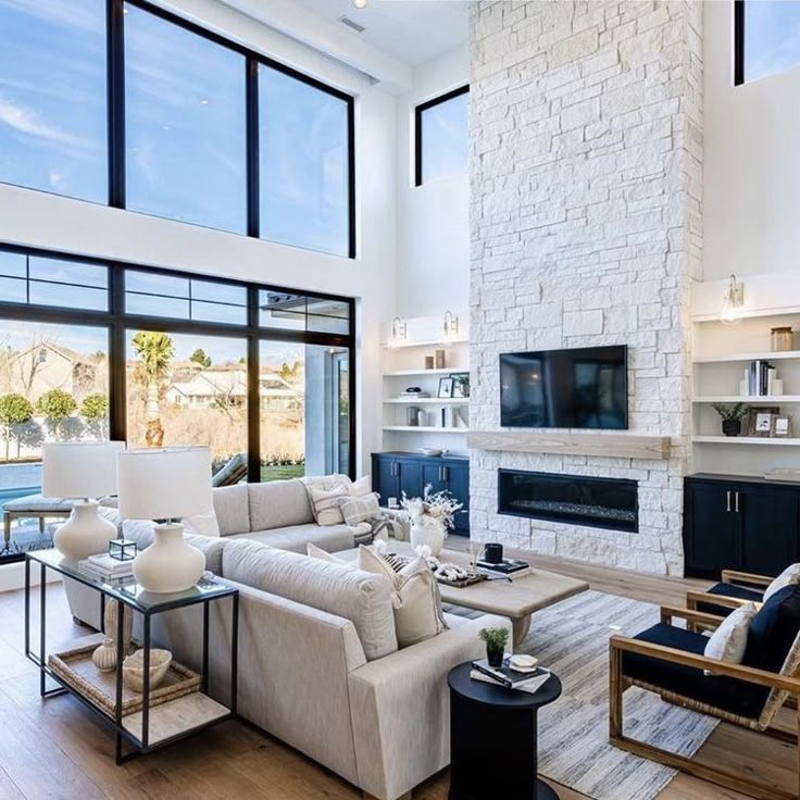 a living room filled with furniture and a flat screen tv mounted to the wall next to a fire place