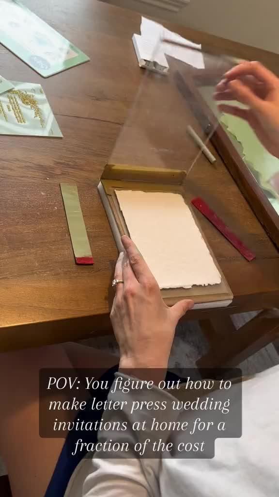 a person sitting at a table with some papers on top of it and an ipad in front of them