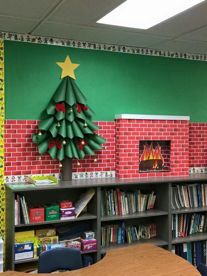 a decorated christmas tree in the corner of a classroom