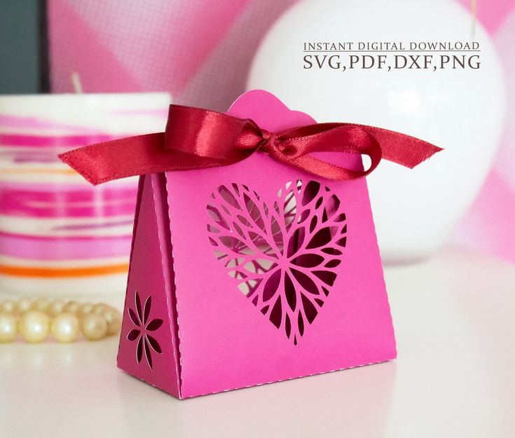 a pink gift bag with a bow on it