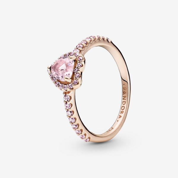 Add a sophisticated touch to your look with the Sparkling Elevated Heart Ring. The ring draws inspiration from the classic Pandora Timeless collection. Hand-finished in 14k rose gold unique metal blend, this piece features a pink heart-shaped central, elevated stone. Clear cubic zirconia create the halo and decorate half of the ring band, with the Pandora logo inside the shank. Stack this ring with hand-finished styles in sterling silver for a statement mixed metal look. - Pandora Sparkling Elev Elegant Pink Gold Heart Promise Ring, Elegant Rose Gold Heart Ring, Elegant Pink Gold Rings For Valentine's Day, Rose Gold Heart Cut Jewelry With Accent Stones, Elegant Rose Gold Heart Ring As Gift, Elegant Pink Heart Ring For Formal Occasions, Elegant Pink Gold Heart Ring For Wedding, Elegant Rose Gold Heart Ring Gift, Elegant Pink Gold Heart Ring