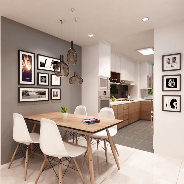 a dining room table with white chairs and pictures on the wall above it in a kitchen