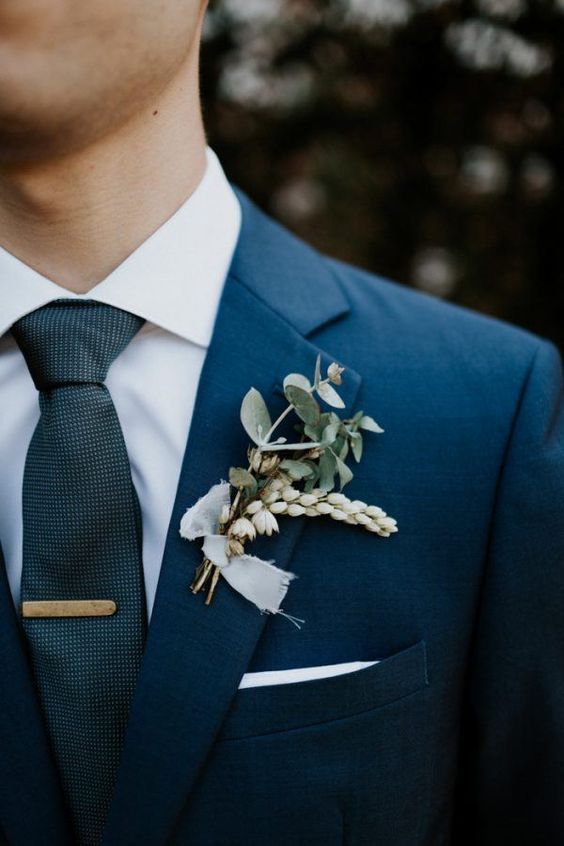 a man in a suit with a boutonniere on his lapel