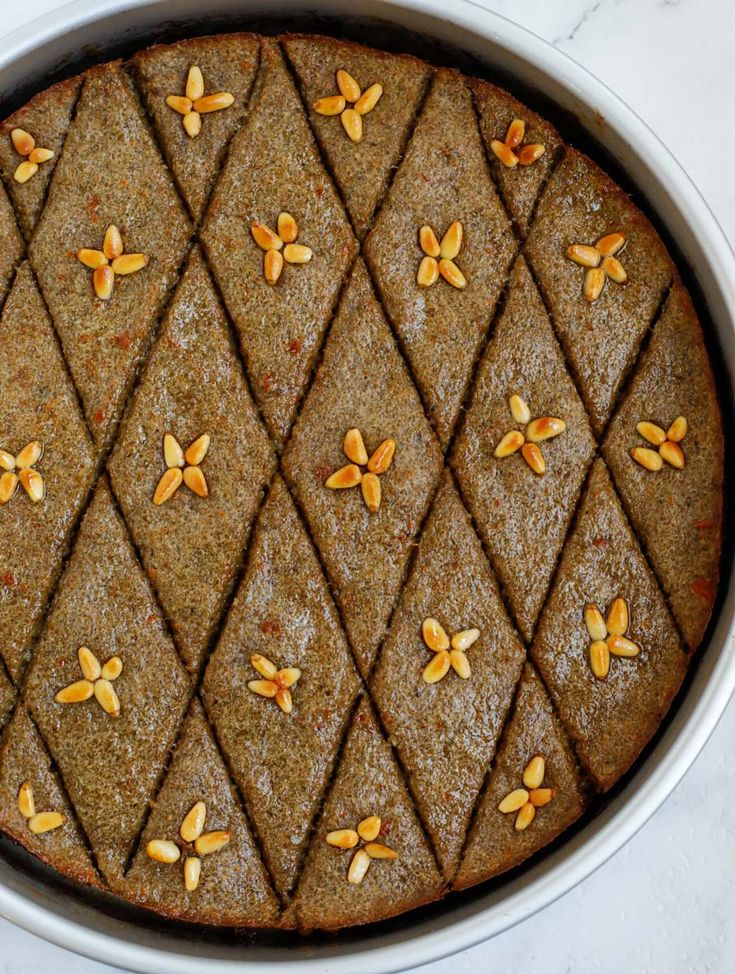 a cake in a pan with almonds on top