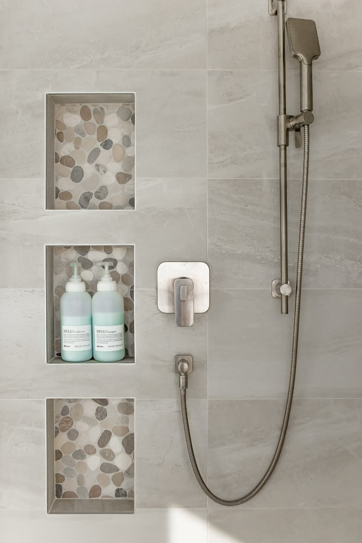 the shower head is connected to two soap dispensers