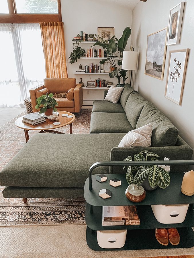 a living room filled with lots of furniture and plants on top of a coffee table