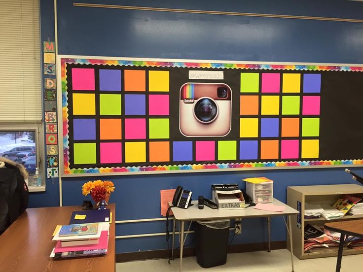 a classroom with a bulletin board decorated with colorful squares and an instagramr on the wall