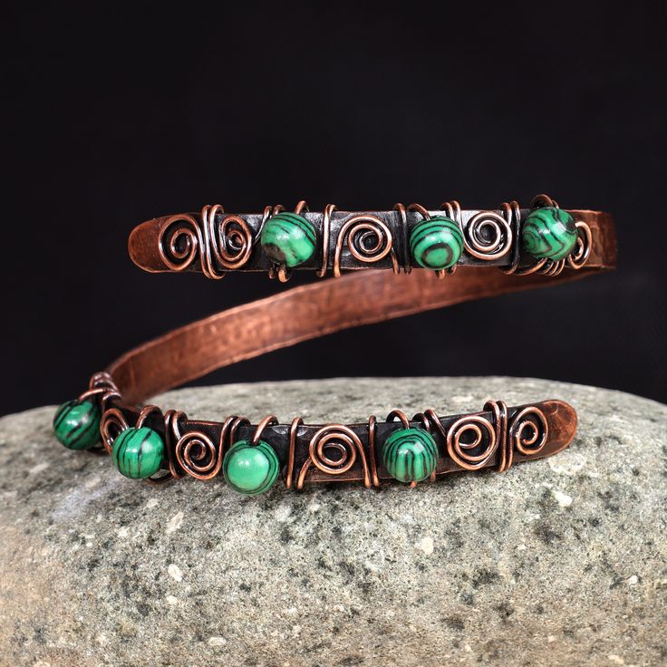 The unique free-form design of this spectacular wrap bracelet draws inspiration from rich Armenian art. Artisans Hasmik and Musheg create this alluring accessory that seamlessly blends copper wires and textured sheets with a captivating antique finish, adorned with enchanting malachite beads. Copper Bangle Bracelets, Antique Copper Jewelry, Handmade Copper Bracelet, Wired Jewelry, Copper Wire Art, Wire Wrap Jewelry Designs, Malachite Bracelet, Copper Wire Jewelry, Malachite Jewelry