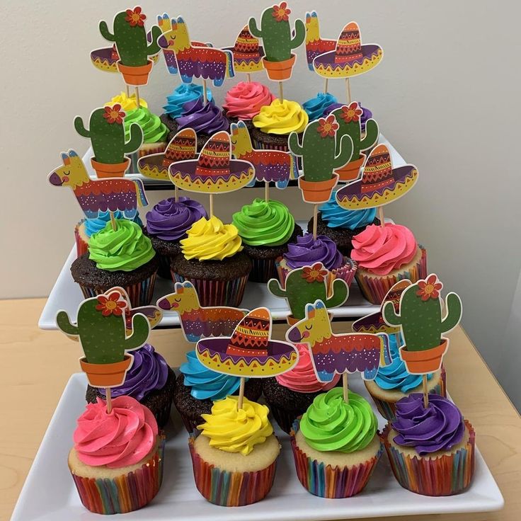 cupcakes are arranged in the shape of a cactus on top of each other