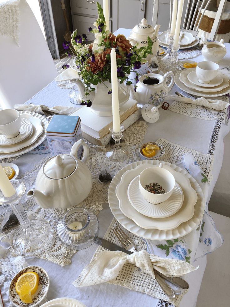 the table is set with dishes, cups and saucers