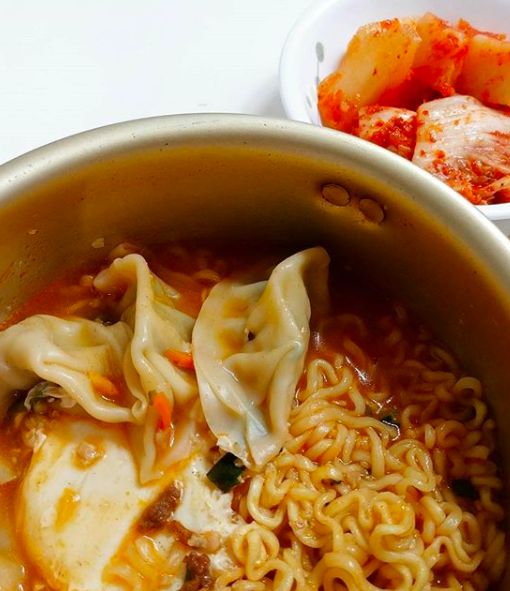 a pot full of noodles and meats on top of a white table with an instagram post