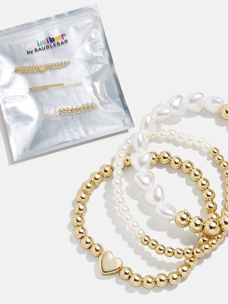 Introduce your little one to a classic combination with this bracelet set: gold and pearls. The Playful Pearls Kids' Bracelet Set includes three individual stretch bracelets with varying beaded and heart-shaped accents. Have a formal family event in the future? Give this to your mini to help them tap into their fancy side. Please note: intended for children 3+ Fancy S, Personalized Placemats, Gold And Pearls, Ballerina Kids, Kids Bracelet, Donuts Earrings, Holiday Headbands, Placemats Kids, Kids Headbands