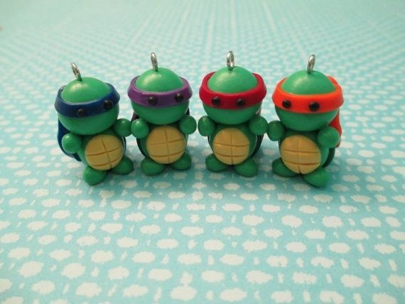 three little turtles are sitting next to each other