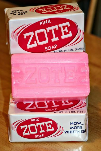 three pink soap bars stacked on top of each other in front of a wooden table