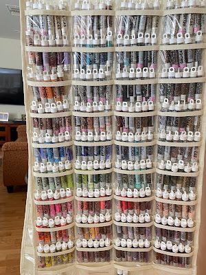 a large display case filled with lots of different colored markers and crochet hooks