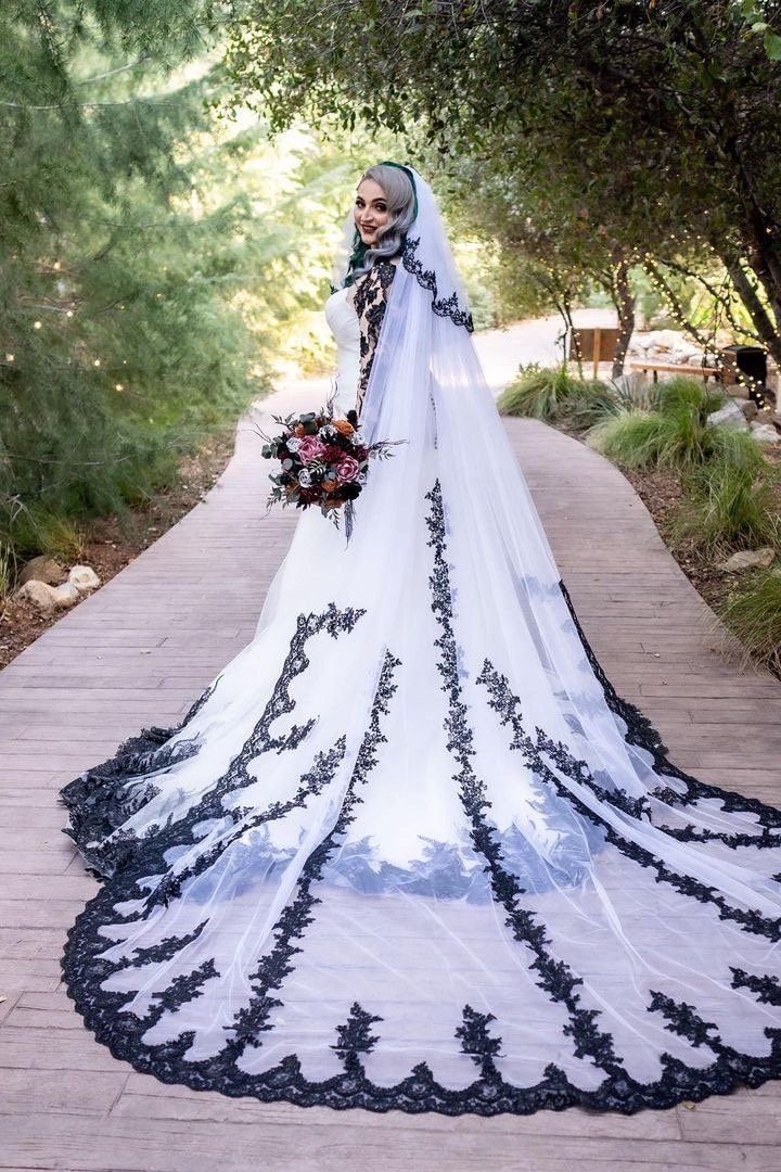 a woman in a wedding dress standing on a walkway