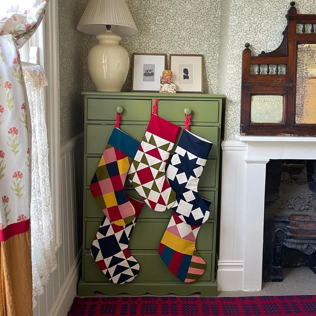 stockings hanging on the wall in front of a fireplace