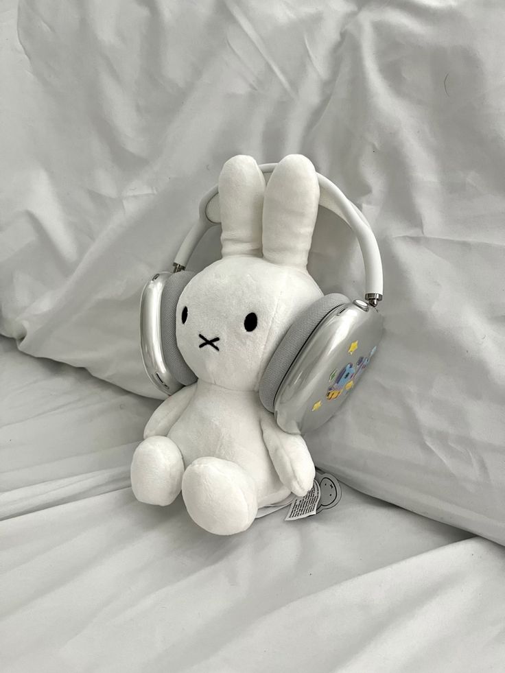 a white stuffed animal with headphones on it