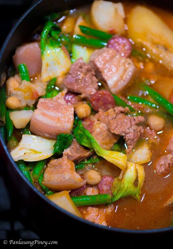 a pot filled with meat and vegetables on top of a stove