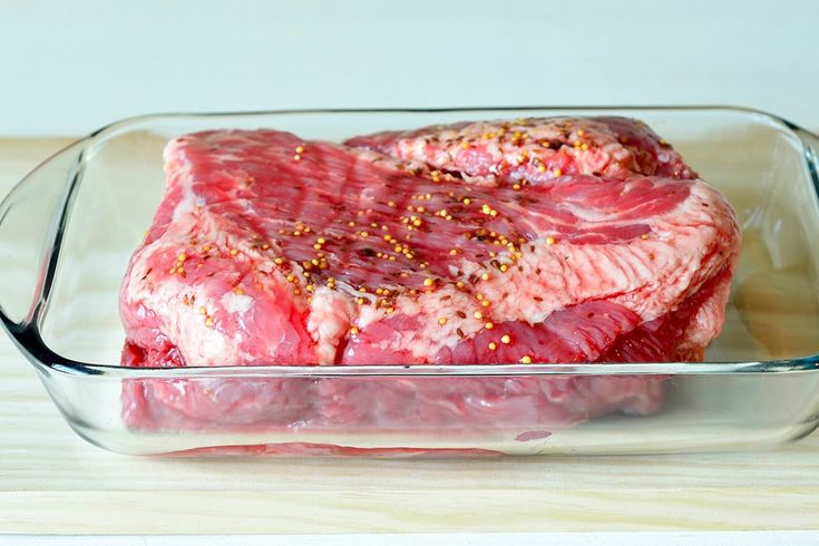 a piece of raw meat in a glass dish