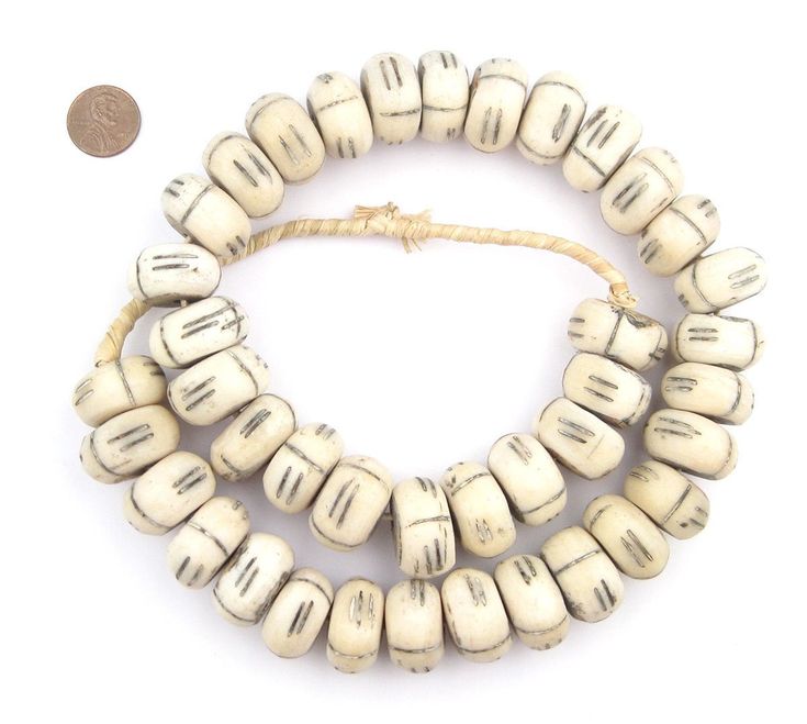 "Admire this beautiful strand of bone beads from Kenya. East African bone beads are handcrafted by artisans using recycled cow bone. Each bead is individually carved and polished, and is truly one of a kind. These beads measure approximately 12-14 x 22-24mm, with a hole size of 3mm. Strands measure approximately 26, and have approximately 40 beads each. Due to the handmade nature of these beads some beads may have a wood core that is more secure than others. Bead Size: 12-14 x 22-24mm Strand Len Traditional Heishi Beaded Necklaces, White Beaded Bracelets With Large Oval Beads, White Beaded Bracelet With Oval Large Beads, Traditional White Beaded Bracelets With Spacer Beads, Traditional Large Heishi Beads, Cow Bones, Structured Bag, Carved Bone, Bone Beads