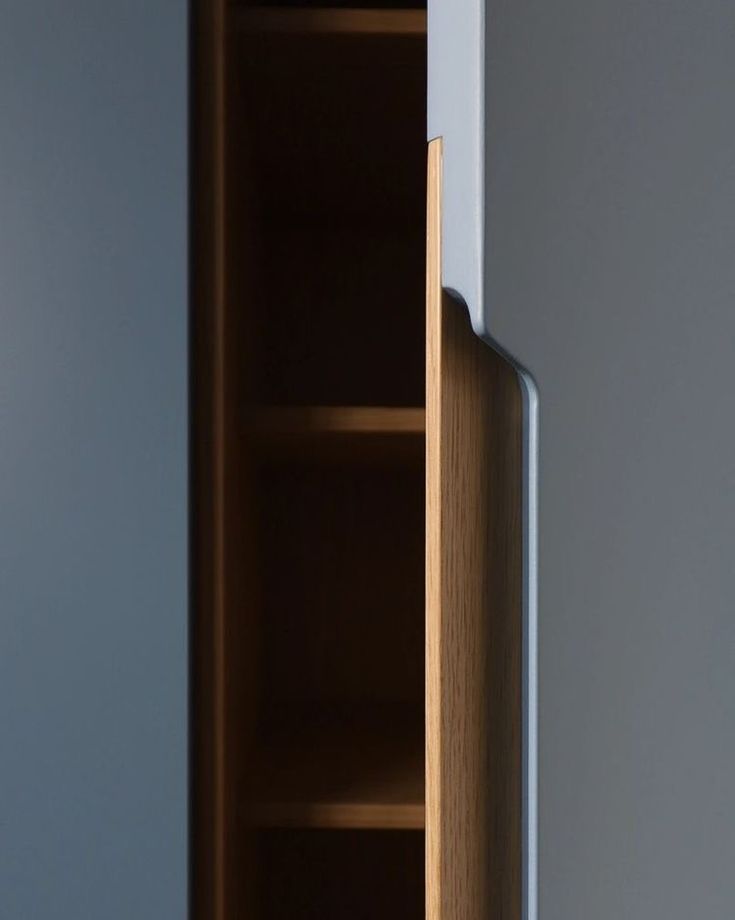 an open cabinet door in the corner of a room