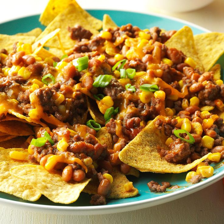 a plate with nachos and corn on it