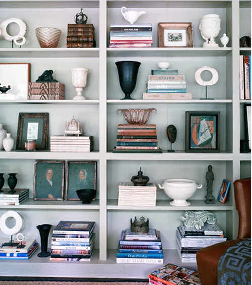 a white book shelf filled with lots of books