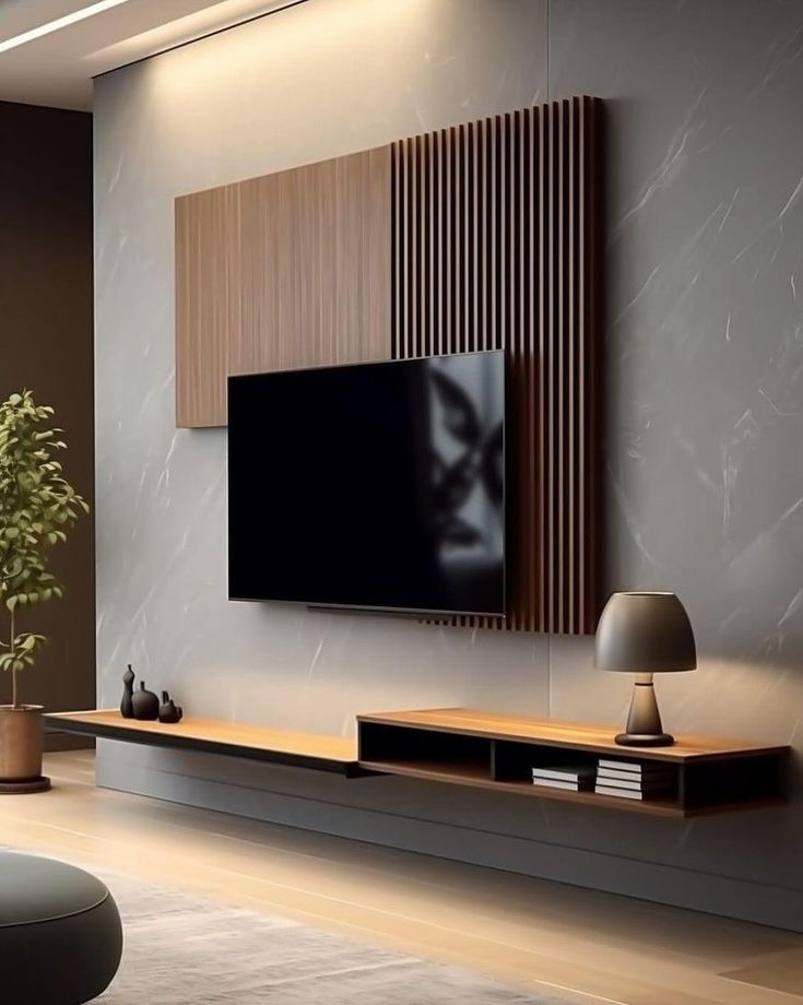 a living room with a large flat screen tv mounted on the wall next to a potted plant